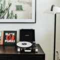 Record player with modern art behind it