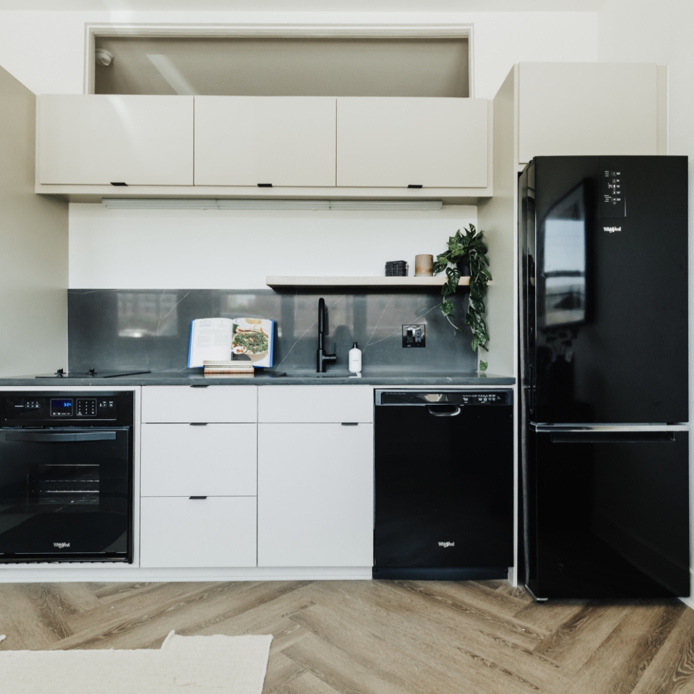 White kitchen with black appliances
